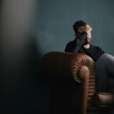 Person sitting alone in quiet thought, illustrating the internal experience of OCD reassurance-seeking